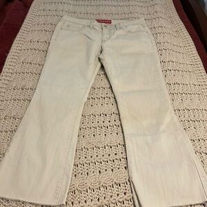 Levi super low stretch, denim pants juniors‎ size 7 medium tan color raw hem.